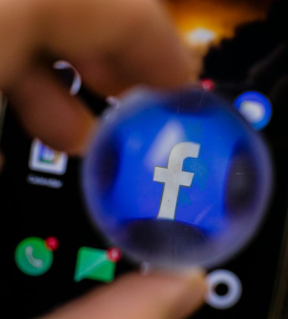 Close-up view of the Facebook app icon magnified on a smartphone screen.